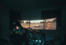 Are Vehicle Simulators the Future of Racing Games? Full-motion racing cockpit in dim basement.